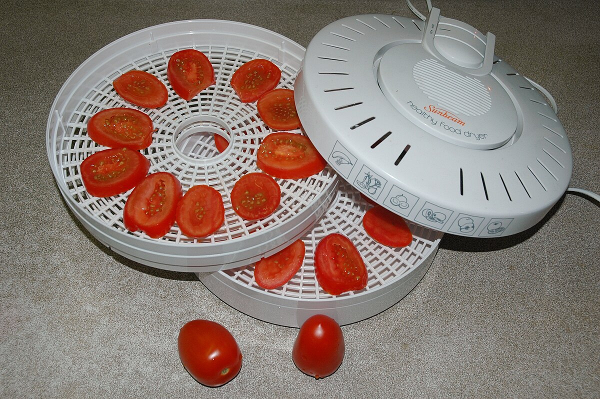 Industrial food dehydrator machine. Professional fruits and vegetables dehydration  machines. Long red pepper in it. Peppers can be dried in the oven a Stock  Photo - Alamy