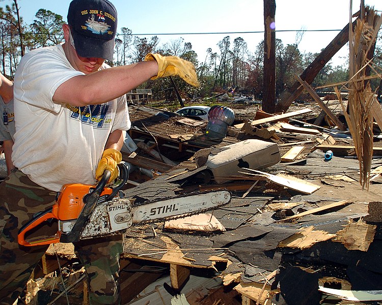 File:US Navy 051019-N-3729H-257 U.S. Navy Draftsman 2nd Class Robert Smith, assigned to the Nimitz-class aircraft carrier USS John C. Stennis (CVN 74), prepares to cut into a destroyed house with a chainsaw.jpg