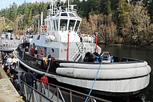 US Navy vessel Valiant (YT-802) US Navy 100209-N-2143T-001 Rob Campbell, deputy program director of Navy Region Northwest Port Operations, delivers remarks during the activation ceremony for the new Navy tug boat Valiant (YT 802).jpg