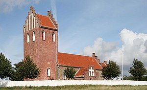 A small village church on a bright day.