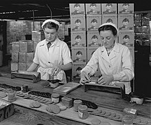 Women working in Wright's Biscuits factory with boxes behind displaying Attwell's Mischief design Wrights Biscuit Packing.jpg