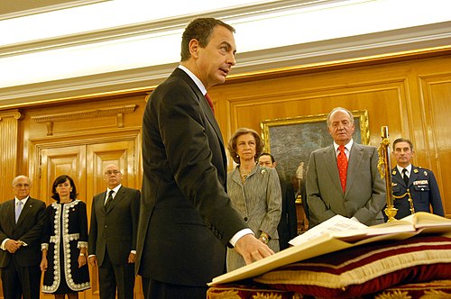 José Luis Rodríguez Zapatero taking the affirmation of office in his second inauguration in 2008. While placing, as mandated, the right hand in the Constitution, being a non-religious, he waived the Bible and the Crucifix.[110]