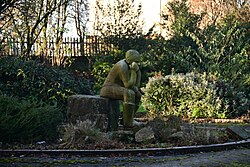 A pensive sculpture of St. Peter in a space dubbed 'Thinker's Corner' in Kingston upon Hull. The sculpture, co-created by Frank Redpath and Kevin Storch and recently reunited with its missing nose, sits on the site of the former St. Peter's Church along Great Union Street, which was destroyed by bombing action during the Second World War in 1941.