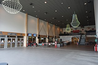 Vänster: Foajé till arenan med cafeteria och sportbar. Höger: Interiör av ishallen med ståplatsläktare i vänster i bild.