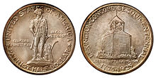 A silver coin bearing the stature of a man in 18th century clothing. He holds a rifle, and his coat is on a plow beside him.