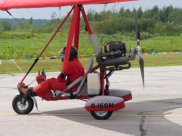 Air Creation Racer ultralight trike with Rotax 503 mounted up-right. Below the muffler is the smaller after-muffler.