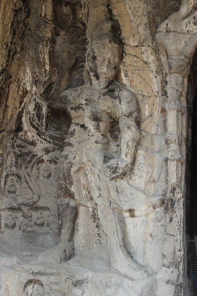 File:Ancient Buddhist Grottoes at Longmen- Grotto of Medical Prescriptions, Celestial Guardian on South Side of Entrance.jpg