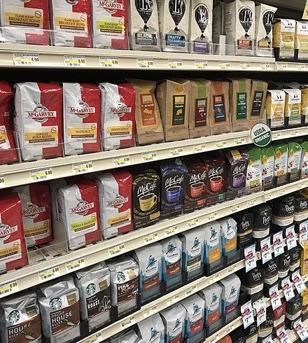 Pre-packaged bags of coffee beans and ground coffee at supermarket