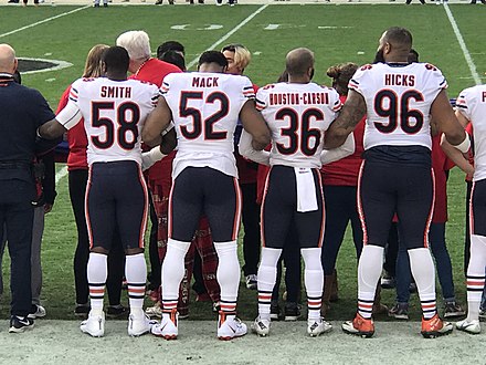Smith with Khalil Mack, DeAndre Houston-Carson, and Akiem Hicks of the Chicago Bears in 2018