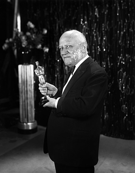 Carl Laemmle holding the Outstanding Production Best Picture Oscar
