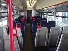 The poles and grab handles on this Class 165 train are of a contrasting colour to assist visually impaired passengers. This is a reasonable adjustment in respect of the DDA. Class 165 train refurbished interior.jpg