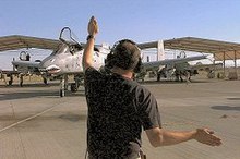 A 23rd Fighter Group member directs traffic in the desert. Desert04b.jpg