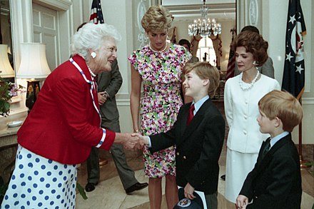 Shaking hands with Barbara Bush, 1991. His mother, Diana, and brother, Harry, look on.