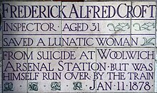 Memorial at Postman's Park to Inspector Frederick Croft, a railway police officer who lost his life saving a woman's life at the station in 1878. Frederick Alfred Croft.jpg