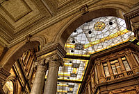 Galleria Alberto Sordi shopping arcade in Rome: main entrance, arches and stained glasses. Author: Bernardo Marchetti