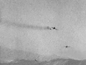 A FJ-2 Fury launches a Gimlet rocket against a F6F target drone Gimlet FJ-2 F6F.jpg