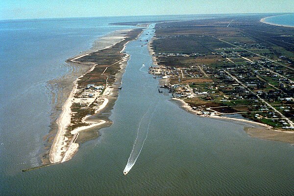 Aerial view of Port Bolivar at the end of the Bolivar Peninsula in 1999. The Gulf Intracoastal Waterway enters Galveston Bay here. Galveston Bay is at
