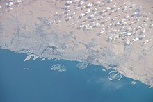 Aerial view of Dubai. Al Muntazah is located approximately halfway between the clearly visible Palm Jumeirah (left) and Palm Jebel Ali (right), just inland from Sheikh Zayed Road ISS062-E-45341 - View of United Arab Emirates.jpg