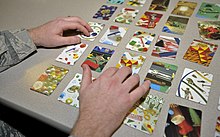 A patient in a traumatic brain injury clinic plays a game of "I Spy" with photographic cards, to help with cognitive functions that may have been lost I Spy cards.jpg