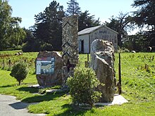 The railway goods shed at Kelso sits behind a monument to the Kelso flood. Kelso Monument.JPG