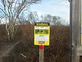 A tick warning sign can be found along the south side of the overlook,...