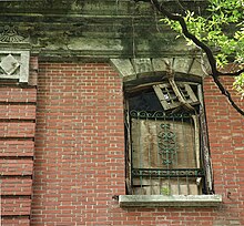 Red brickwork on outer wall and window grilles. Nam Koo Terrace Windows.jpg