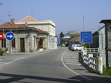 Border between Spain and Portugal, parties to the Schengen Agreement. Their border is marked with a simple sign and no passport checks or customs controls. Ponteminho4.jpg