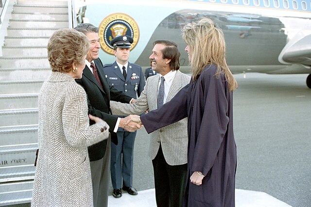 President Ronald Reagan and First Lady Nancy Reagan are greeted by Sonny Bono and Mary Bono on their arrival via Air Force One in Palm Springs, Califo