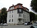 Apartment house in a corner and open development