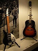 Rickenbacker 325 (c.1964, black, white pickguard), Epiphone EJ-160E (sunburst) - Exposition John Lennon unfinished music - Musée de la musique (2006-04-30 15.36.36 Benoit Darcy).jpg