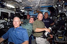 STS-117 crewmembers in the Destiny laboratory. STS117 Crew Flight Day5.jpg