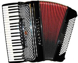 A picture of a red and black button accordion