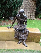 Seated statue of St Edmund of Abingdon in the churchyard. St Edmund bronze.jpg