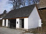 Stucco hut and weapon collection