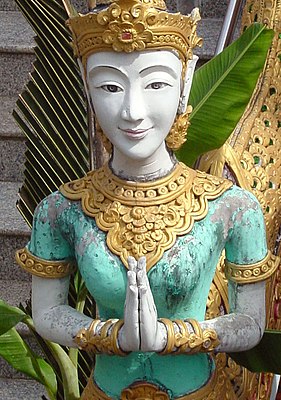 Statue with namaste pose in a Thai temple