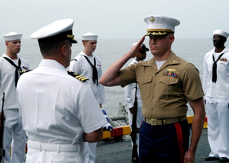 File:US Navy 050730-N-3666S-104 Cmdr. Steven Halpern receives the ensign from Maj. David Williams during one of three burial at sea ceremonies conducted aboard the amphibious assault ship USS Wasp (LHD 1).jpg