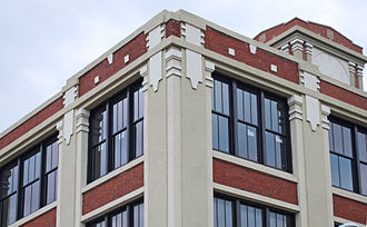 Detail of exterior, top northeast corner, showing ornamental pilaster capitals and decorative insets. VassarSwissUnderwearCoBldgChicagoC.jpg