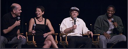Robert Picardo, Roxann Dawson, Ethan Phillips, Tim Russ at a Voyager panel in 2009; they played the roles of The Doctor, B'Elanna Torres, Neelix, and Tuvok, respectively