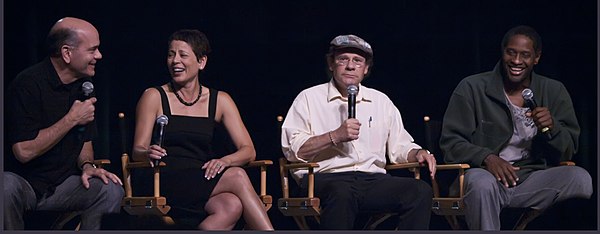 Robert Picardo, Roxann Dawson, Ethan Phillips, Tim Russ at a Voyager panel in 2009; they played the roles of The Doctor, B'Elanna Torres, Neelix, and 