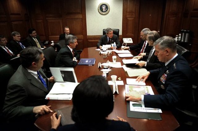 President George W. Bush during a National Security Council (NSC) meeting at the White House Situation Room, March 21, 2003. The participants in the m