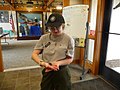 Americorps interpreter showing a baby turtle to visitors (14037836264).jpg