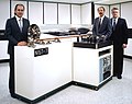 NIST-7, the seventh generation of atomic clocks at the National Institute of Standards and Technology, and three of the researchers who spent seven years developing one of the world's most accurate clocks. From left to right, John P. Lowe, Robert E. Drullinger, the project leader, and David J. Glaze.