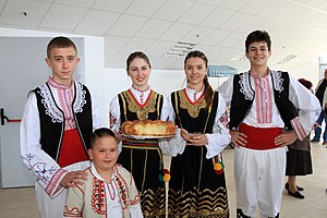 Children in Bulgarian national costumes welcome guests during the Folklore Festival, Slivnitsa, Bulgaria. Children in Bulgarian national costumes.jpg