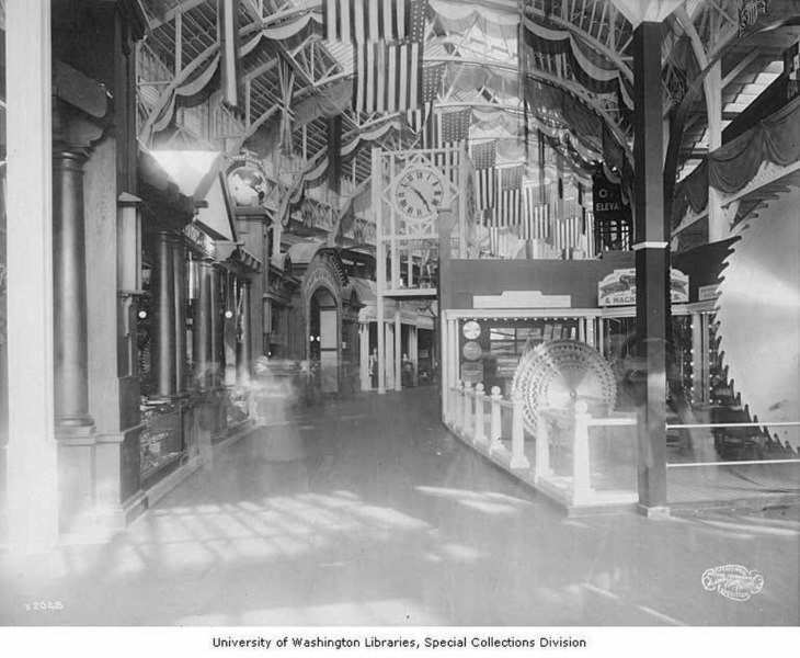 File:Corridor of exhibits featuring multi-layered saw, Manufactures Building, Alaska-Yukon-Pacific-Exposition, Seattle, Washington (AYP 1142).jpeg