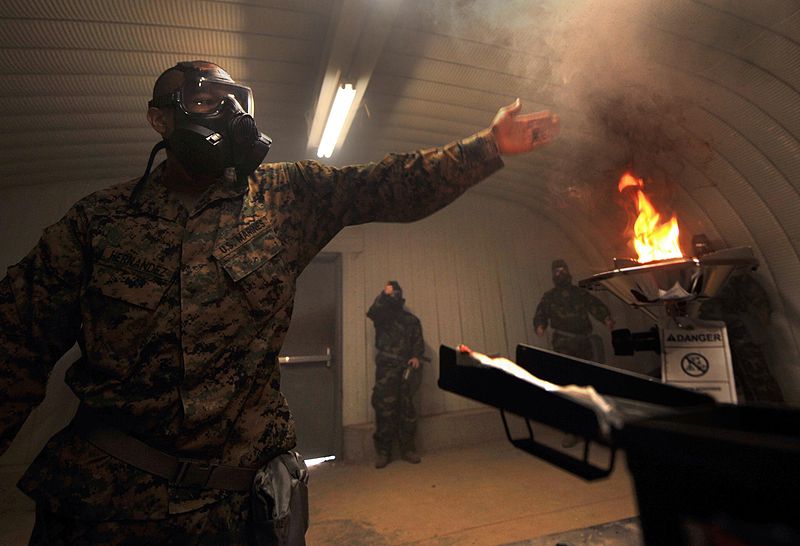 File:Cpl. David M. Hernandez, 11th Marine Expeditionary Unit, uses a burner to activate tear-gas particles in a chamber here March 10 during training in which approximately 100 unit members drilled with XM50 110310-M-GY762-204.jpg