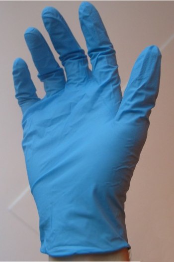 A disposable nitrile rubber glove. Nitrile glo...