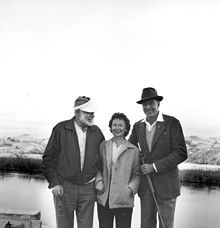 photograph of two men and woman
