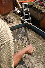 An archaeologist searches for evidence of glass objects among ruins Fort Monroe Contraband Archaeological Dig (4711446209).jpg