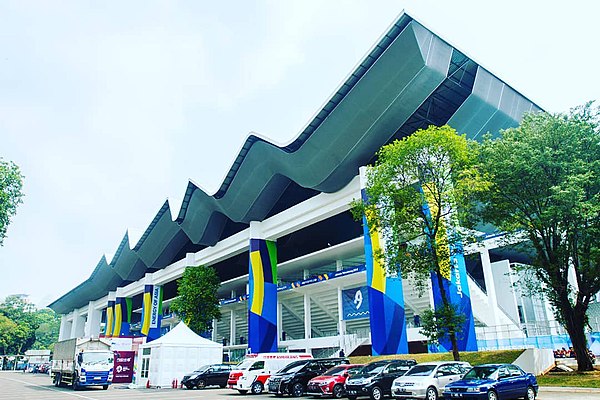 Gelora Bung Karno Aquatic Stadium. The 2016–17 renovation introduced a new, wave-shaped roof above the arena which originally only had roofs at the tr