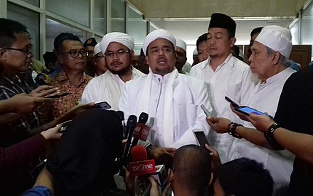 Rizieq Shihab faces the media after being implicated in an alleged pornography case.